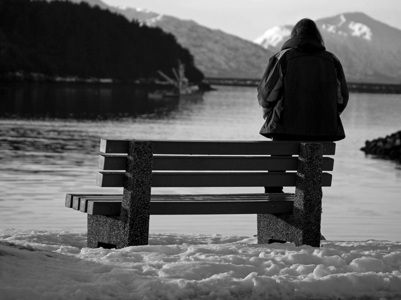 Man sitting on a bench in the snow